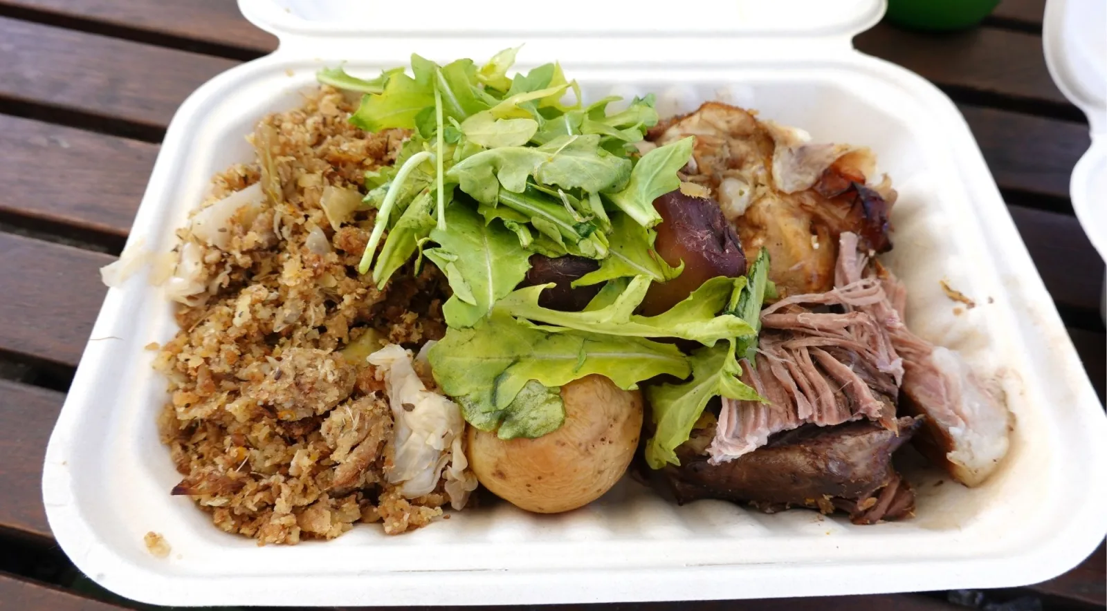 Takeaway hāngī box of pulled pork, stuffing, potato and fresh greens