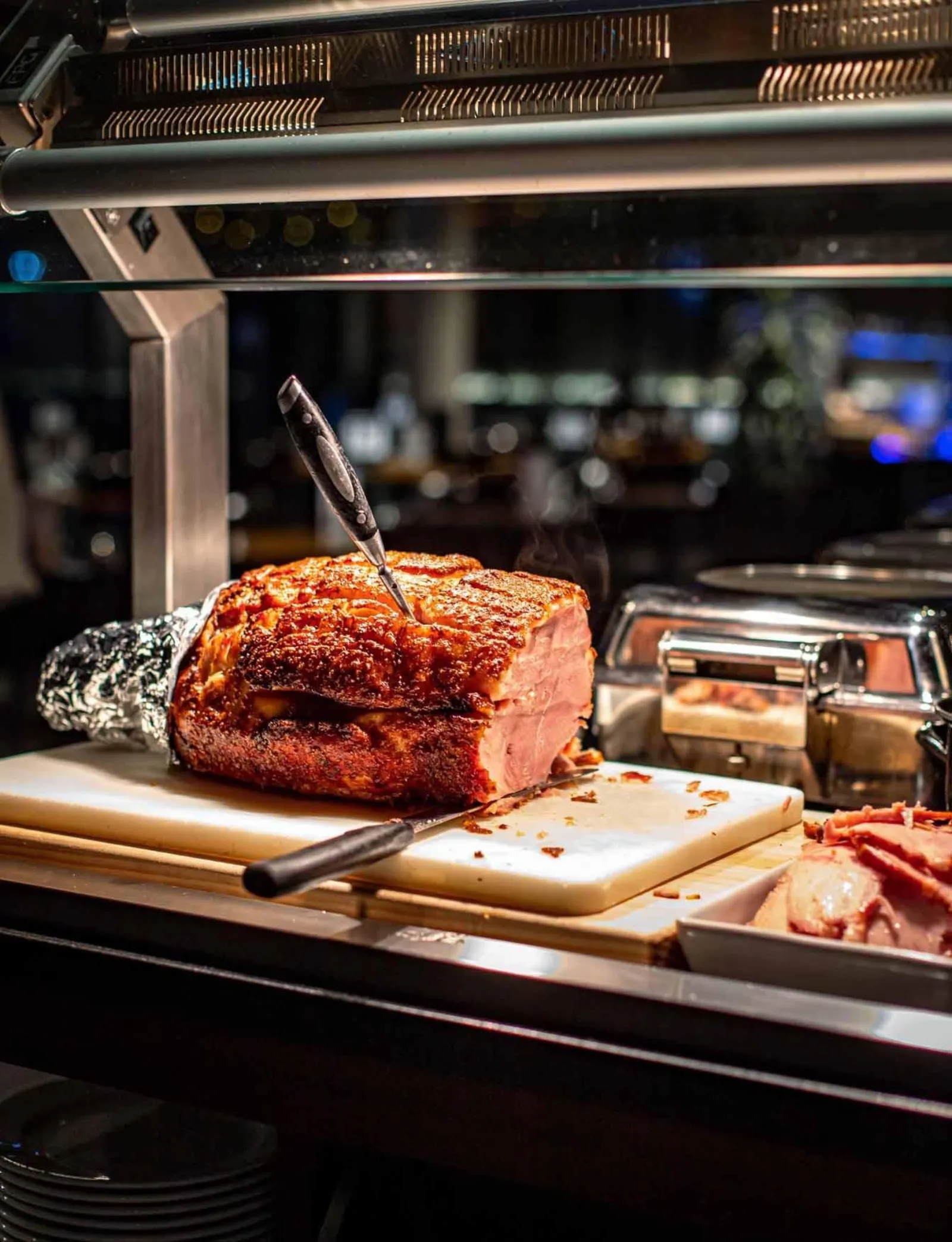 Carved roast pork at the buffet carvery station