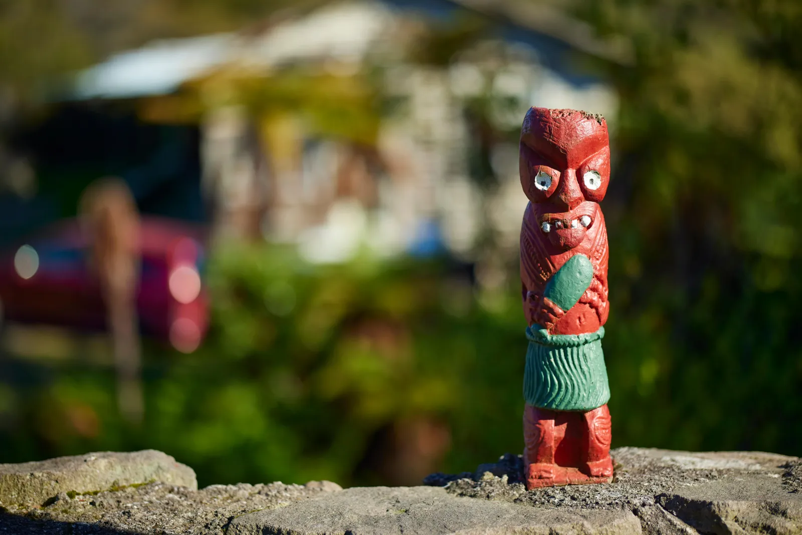 A small carved figure on a rock at the edge of the village