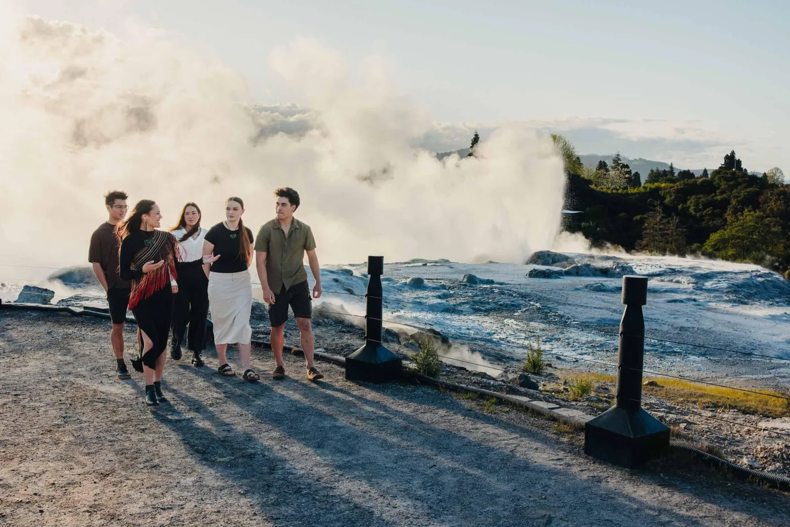 Visitors on the terrace as Pōhutu Geyser erupts behind them